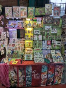 Messestand von Julia Klein Illustration mit Kunstdrucken, Stickern und illustriertem Tischbanner